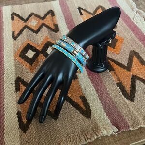 Lot of three costume jewelry bracelets with gold, silver, and turquoise tones